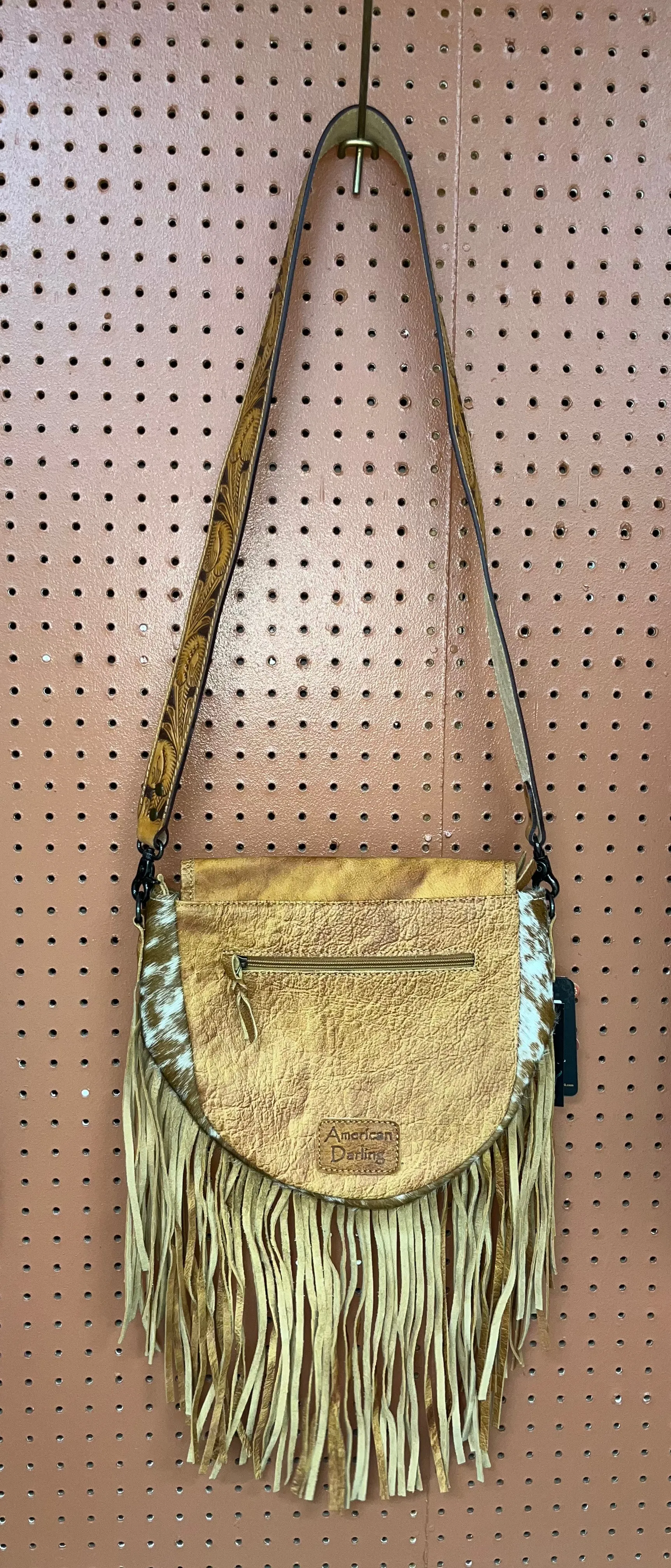 Rounded cowhide and leather crossbody