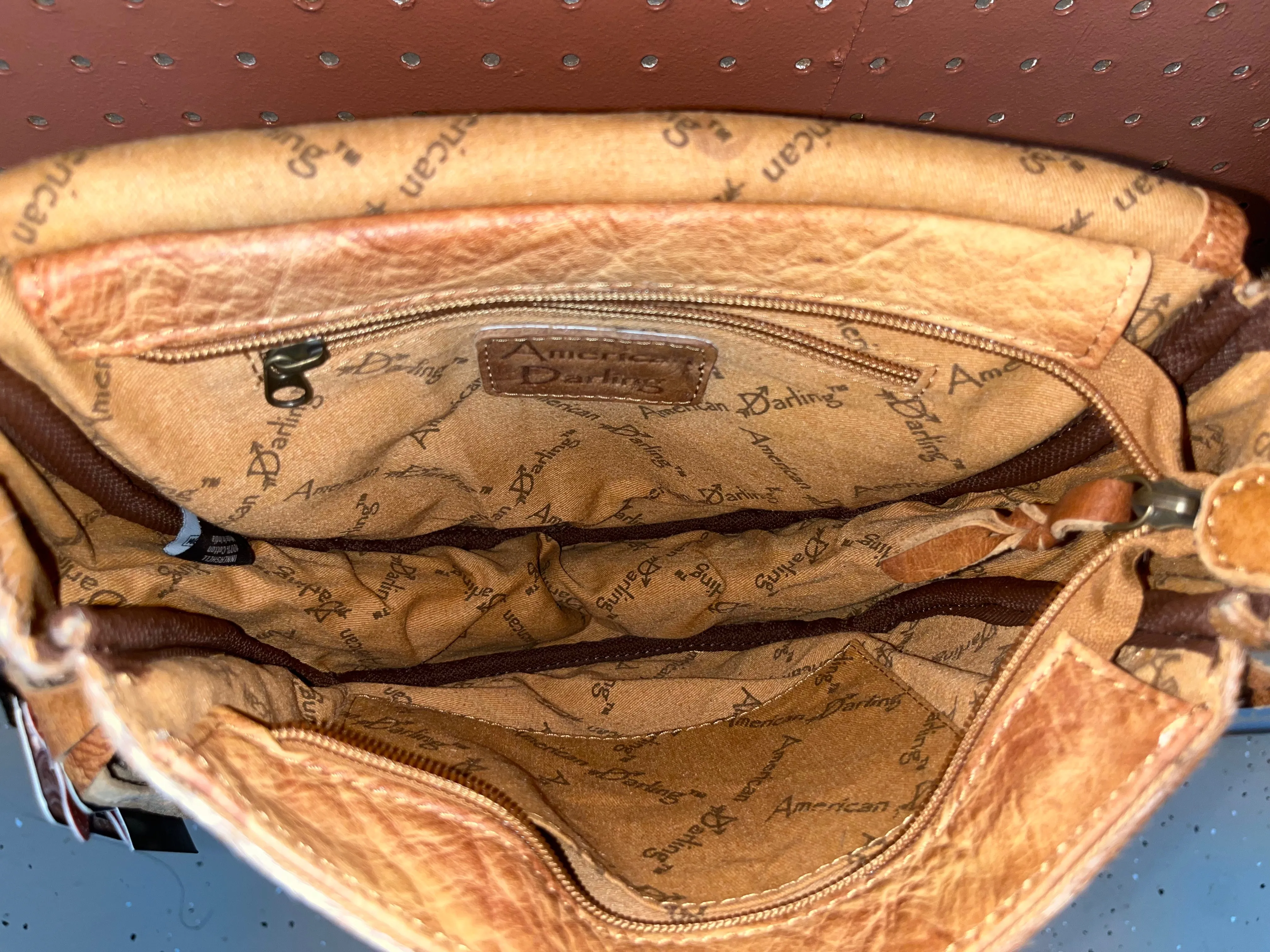 Rounded cowhide and leather crossbody